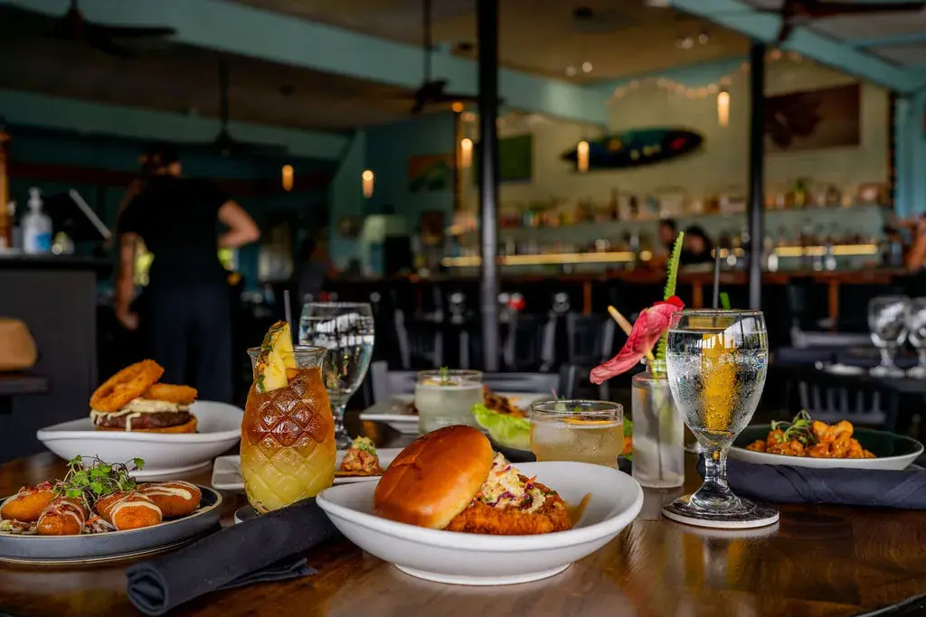 Happy hour spread of handcrafted cocktails, local beers, and shareable pūpū at Jackie Rey's Kona.
